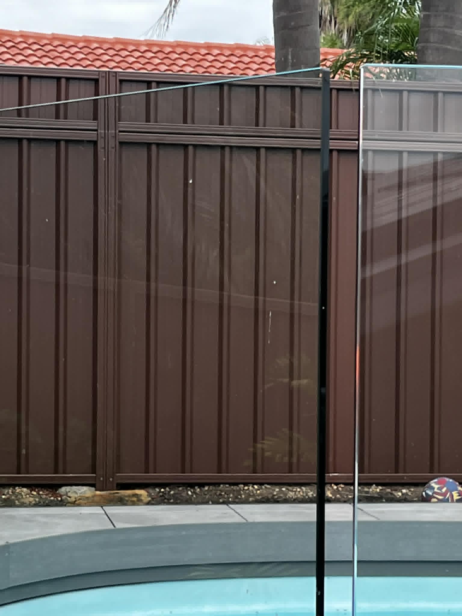 Colorbond fence extension beside a Sydney pool