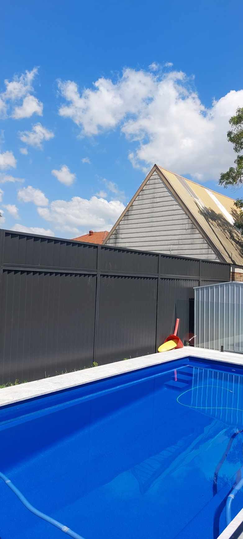 Colorbond fence extension beside a Sydney pool