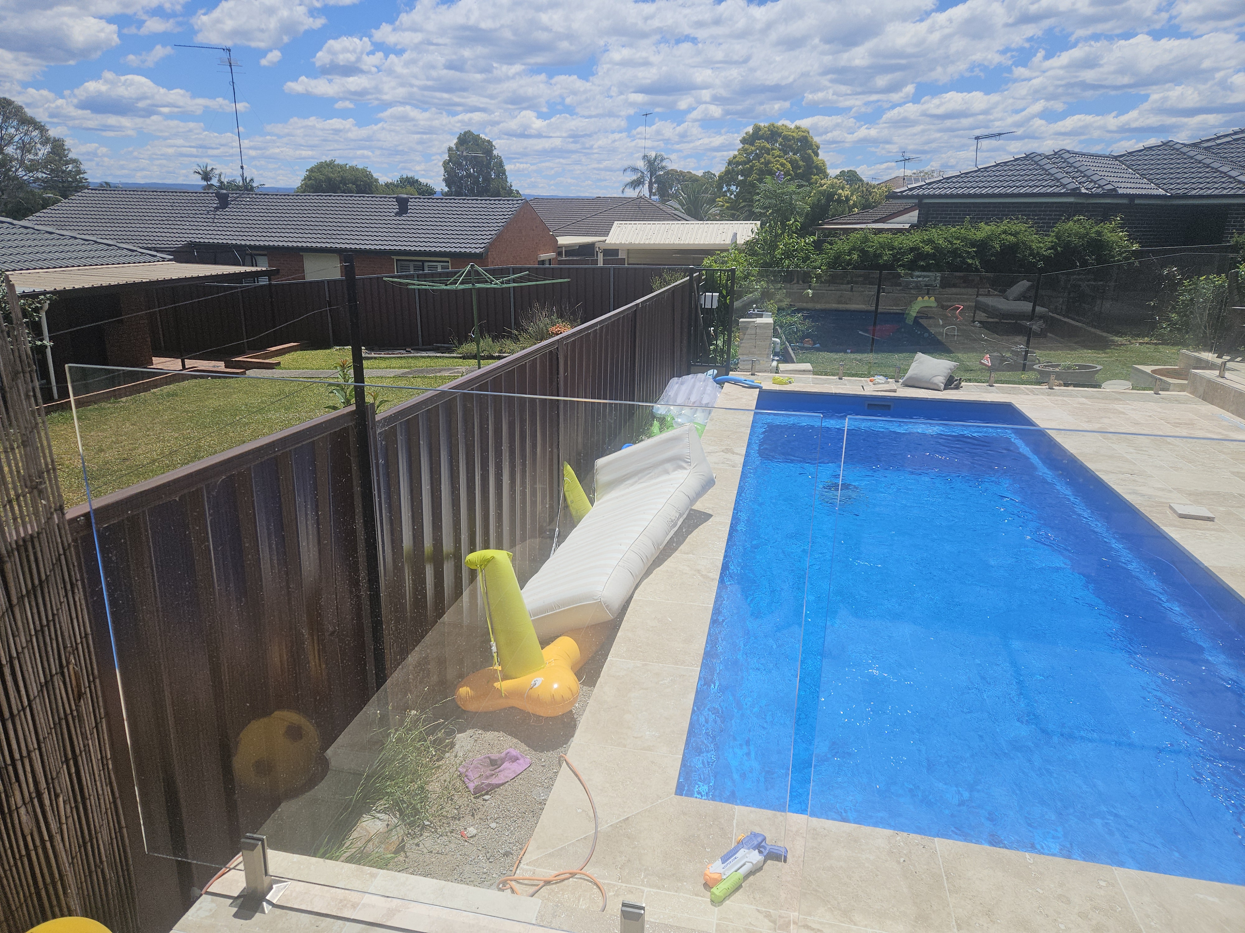 Frameless glass pool fence around a Sydney backyard pool