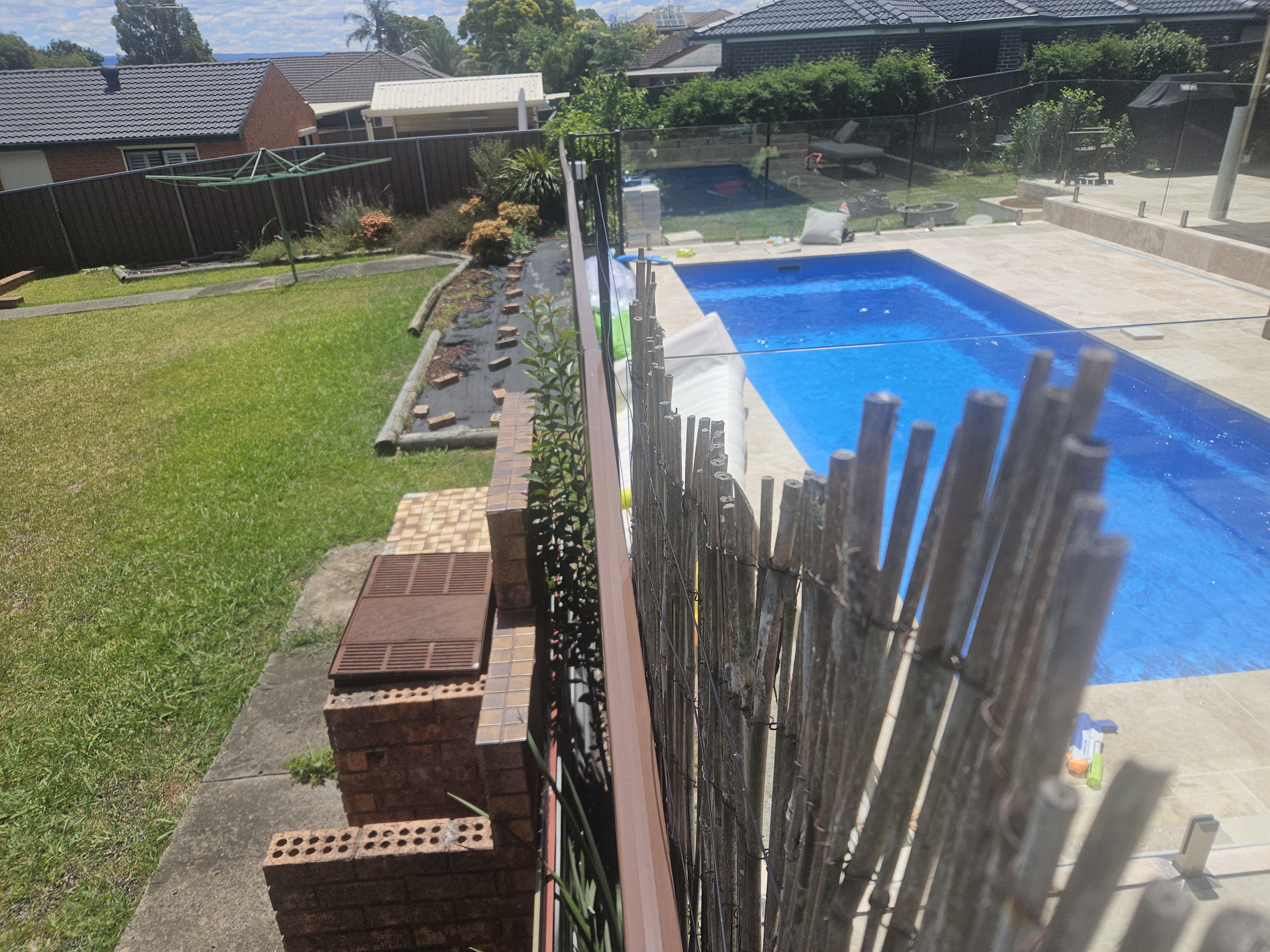 Black pool fence panels installed in a backyard